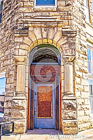 Old rock theater built in 1928 in Fairfax Oklahoma USA boarded up corner arched entrance because the roof of the building was Stock Photo