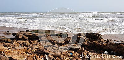 old rocks in front of sea waves Stock Photo