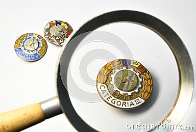 Old romanian sport badges from the 50`s looked through a magnifying glass Editorial Stock Photo