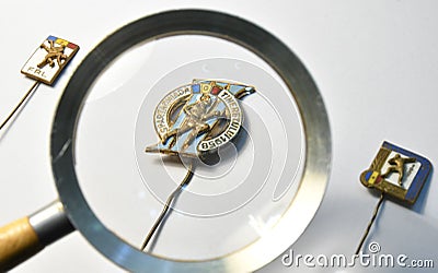 Old romanian sport badges from the 50`s looked through a magnifying glass Editorial Stock Photo