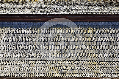 The old roof of an ancient barn, created from wooden shards, darkened by weather influence Stock Photo