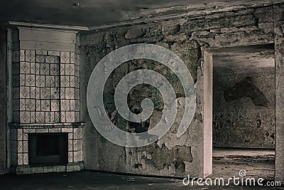 An old room with an antique fireplace and shabby walls. Stock Photo