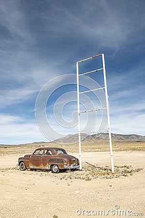 Old rotten vintage car at a patrol station in the desert at Route 895 at Rachel, Alamo, Nevada Stock Photo