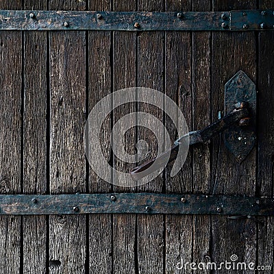 Old rotten wormy ancient oak door and metal parts, wooden textured castle door Stock Photo