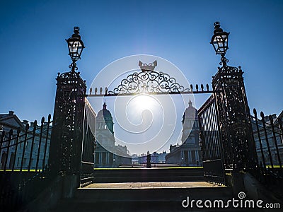 Old Royal Naval College doors entrance near Times river and the sun shining above. Stock Photo
