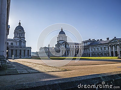 Old Royal Naval College doors entrance near Times river and the sun shining above. Stock Photo