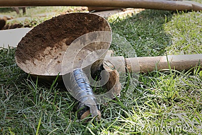 A old rubber hamer with trowel for picking of soil from hard conditions. Lying on the ground in maintance Stock Photo