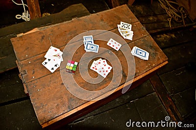 Old Rubik`s Cube and playing cards Editorial Stock Photo
