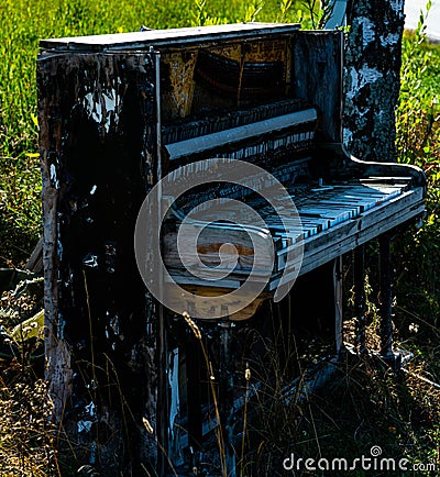 Destroyed piano sitting outside Stock Photo