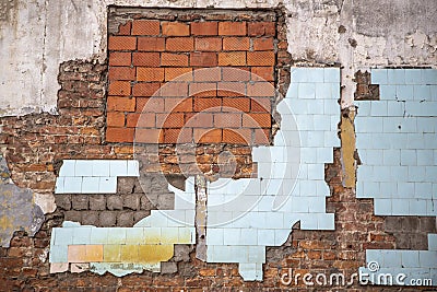 Old ruined red brick wall of a house with blue tile and white concrete. rough surface texture Stock Photo