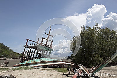 An old ruined sailboat abandoned in the beach Stock Photo