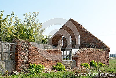 Old ruined stone house in the village. Red brick house built in the last century. Historical value. Demolition of buildings Stock Photo