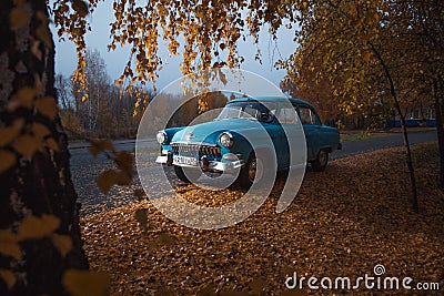 Soviet oldtimer Volga in the autumn forest Editorial Stock Photo