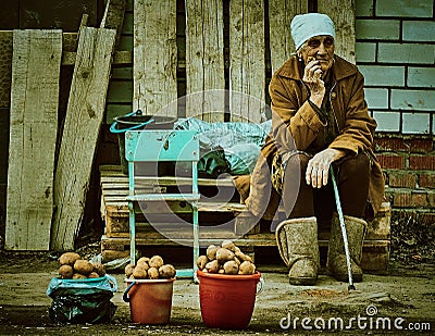 Old Russian woman selling potatoes Kaluga region. Editorial Stock Photo