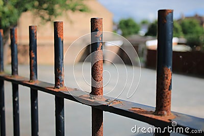 Old rusted black metal railing fence Stock Photo