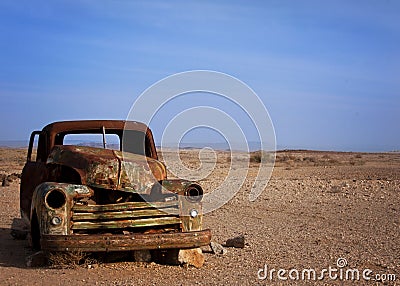 Old rusted car desserted in the desert Stock Photo