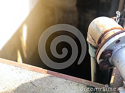 Old Rusted Metal pipeline of Sludge treatment wastewater management system, using for drainage of sewage systems in the factory. Stock Photo