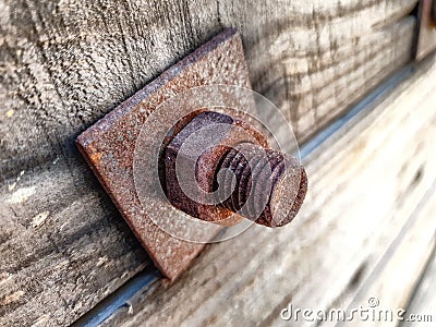 Old rusted nut and bolt on wood Stock Photo