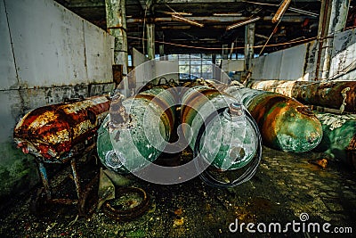 Old rusted submarine torpedoes in abandoned torpedo factory Stock Photo