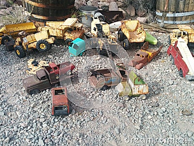 Old, rusted vintage toy vehicles on the ground Stock Photo