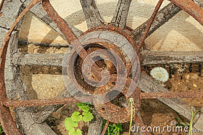 Old rusted wood and metal cart wheel Stock Photo
