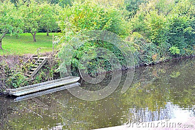 old rustic lonely boat on the river bank in Worcestershire in England Stock Photo