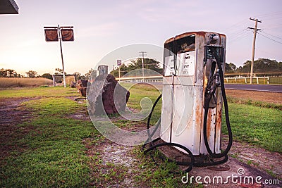 Old rustic pump at an abandoned fuel station Stock Photo
