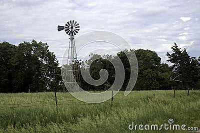 Old Rustic Windmill on Nebraska pasture landscape Stock Photo
