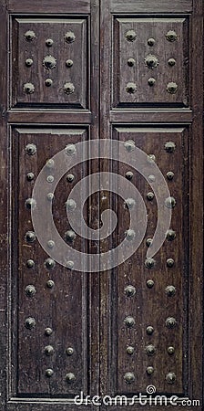 Old rustic wooden door with metal rivet Stock Photo