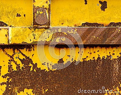 Old rusting metal skip container with yellow pealing paint Stock Photo