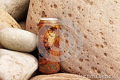 Old rusty aluminum beer of soft drink can on a pink color cobble stones. Nature pollution concept Stock Photo