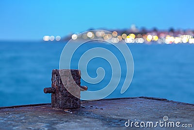 Old rusty bollard on the dock at night Stock Photo