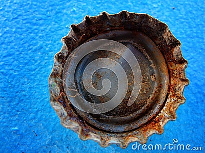 Old Rusty Bottle Cap Bottlecap on Blue Background Stock Photo