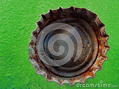 Old Rusty Bottle Cap Bottlecap on Green Background Stock Photo