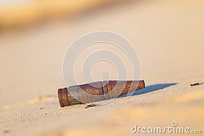 old rusty bullet lie on a sand Stock Photo