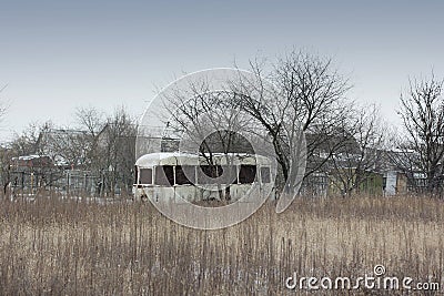 Old rusty bus in the field Stock Photo