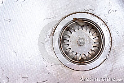 Old rusty calcified drain hole in the kitchen sink with limescale and scurf scum, copy space Stock Photo