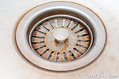 Old rusty calcified drain hole in the kitchen sink with limescale and scurf scum Stock Photo