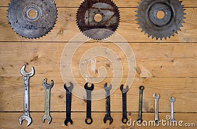 Old rusty circular saw blades and wrenches Stock Photo