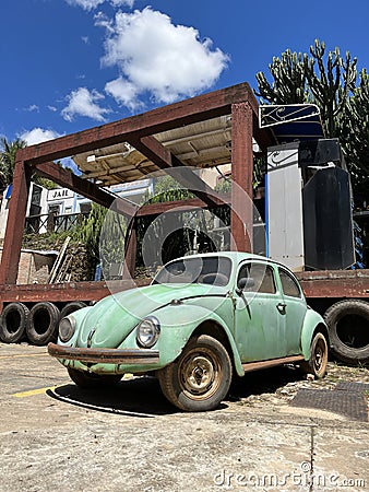 Old and rusty classic green Beetle parked. Stock Photo