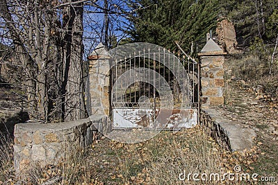 Old rusty closed iron gate at the entrance to the garden Stock Photo