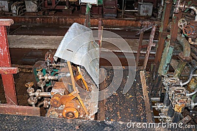 Old rusty closed peeling shop at a abandoned industrial obsolete chemical petrochemical engineering refinery with metal iron pipes Stock Photo