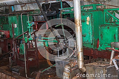 Old rusty closed peeling shop at a abandoned industrial obsolete chemical petrochemical engineering refinery with metal iron pipes Stock Photo