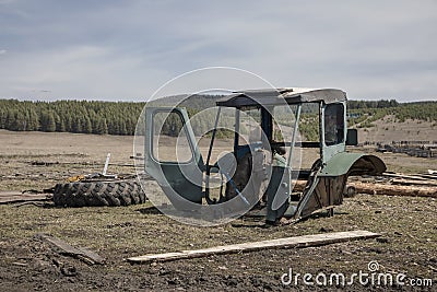 Old rusty dirty abandoned tractor in the field. Stock Photo
