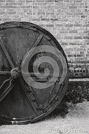Old and rusty drum roller outside an old weaving factory Stock Photo