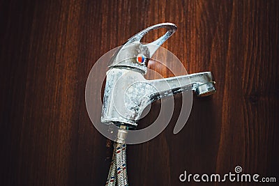 Old rusty faucet on wooden background Stock Photo