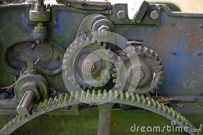 Old rusty gears. Gear wheels in agricultural equipment. Stock Photo