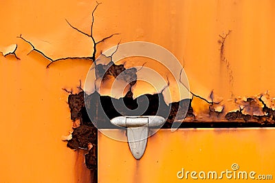 Old rusty hinge detail of orange metal door Stock Photo
