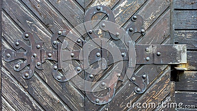 Old rusty hinge on old wooden door Stock Photo