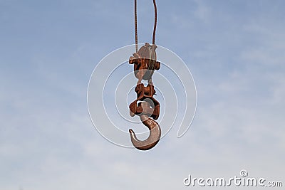 Old rusty hook of a hoisted crane in the port Stock Photo